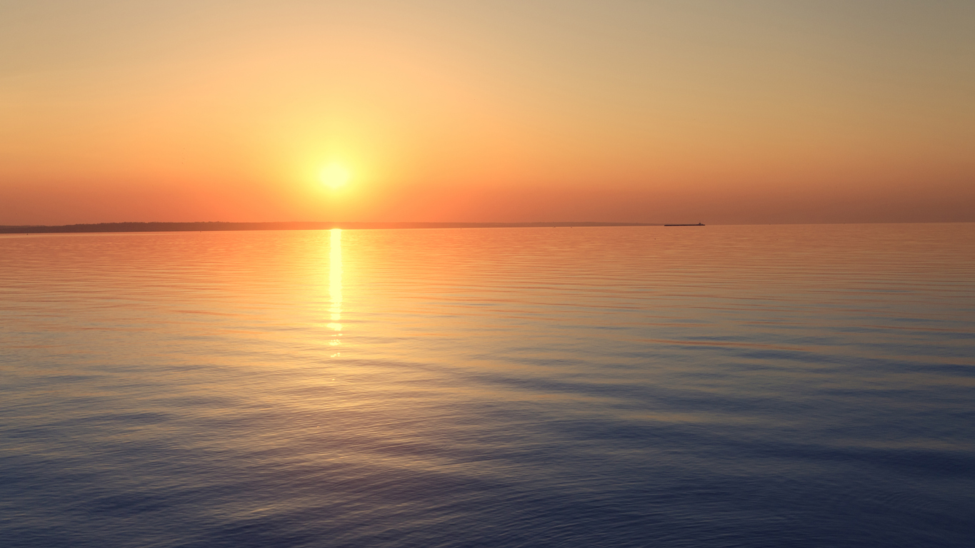 Golden sunrise over a calm ocean with soft reflections, symbolizing inner clarity, peace, and new beginnings.